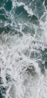 Aerial view of ocean waves with frothy water patterns in teal hues.