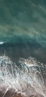 Aerial view of ocean waves crashing on the beach.