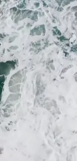 Aerial view of ocean waves with foamy white textures.