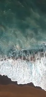 Aerial view of ocean waves crashing onto the shoreline.