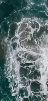 Aerial view of ocean waves creating textured patterns on the sea surface.