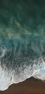 Aerial view of turquoise ocean waves crashing onto a sandy beach.