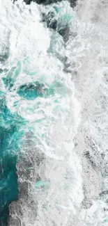 Aerial view of ocean waves crashing with teal and white colors.