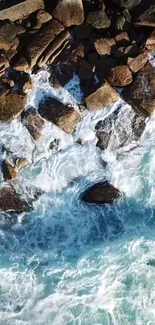 Aerial view of ocean waves crashing onto rugged rocks with vivid blue hues.