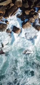 Top view of ocean waves crashing against rocks.