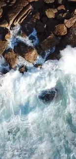 Aerial view of ocean waves crashing against rocky shore.