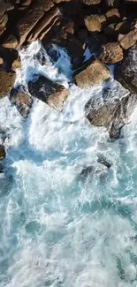 Aerial view of ocean waves crashing onto rocky shore.