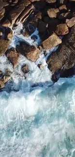 Aerial view of ocean waves crashing on rocky shoreline.