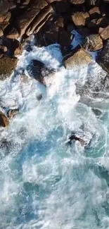 Aerial view of ocean waves crashing on rugged rocks.