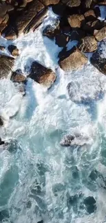 Aerial view of ocean waves hitting rocky shore.