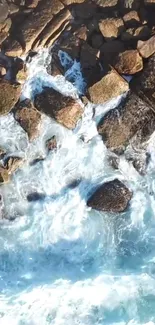 Aerial view of ocean waves crashing against rocks, creating a serene natural scene.