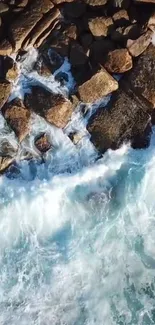 Aerial view of ocean waves crashing on rocks, creating a dynamic mobile wallpaper.