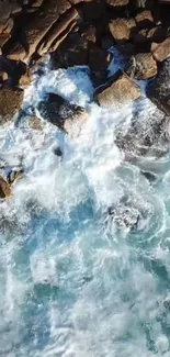 Aerial view of ocean waves crashing on rocky shore.