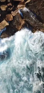 Aerial view of ocean waves crashing onto rocks.