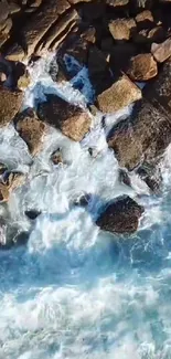 Aerial view of ocean waves crashing on rocky shore.