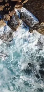 Aerial view of ocean waves crashing on rocky shore in a serene wallpaper.