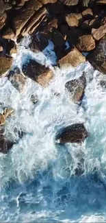 Aerial view of ocean waves crashing on rocky shore.