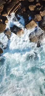 Aerial view of ocean waves crashing against rocky shore.