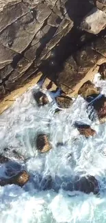 Aerial view of ocean waves crashing on rocky cliffs.