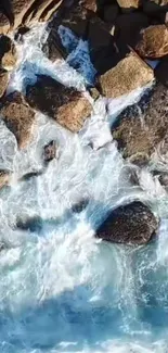 Aerial view of ocean waves crashing on rocks, creating a serene seascape.