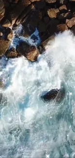 Aerial view of ocean waves crashing on rocky shore.