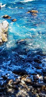 Turquoise ocean waves crashing over rocky shore.