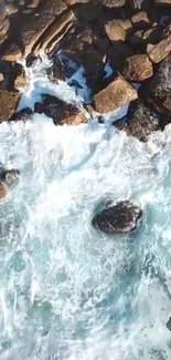 Aerial view of ocean waves crashing onto rocky shore.