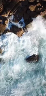 Aerial view of ocean waves crashing against a rocky shoreline.