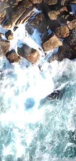 Aerial view of ocean waves crashing onto a rocky shore with dynamic water movement.