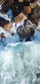 Aerial view of ocean waves crashing against rocky shore.