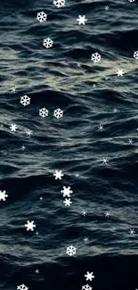 Dark ocean waves with snowflakes overlay mobile wallpaper.