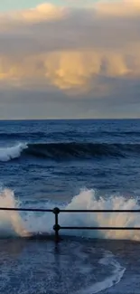 Ocean waves crash against a railing at sunset with a colorful sky.