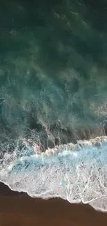 Aerial view of turquoise ocean waves crashing on a sandy beach.