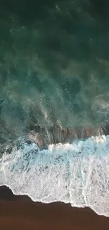 Aerial view of ocean waves crashing onto a beach, creating a tranquil mobile wallpaper scene.