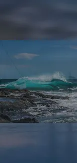 Ocean waves crash against rocky shore under a bright blue sky.