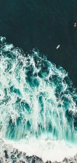 Aerial view of ocean waves crashing with surfers nearby.