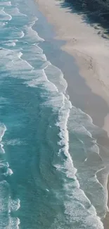 Turquoise ocean waves crashing on a peaceful sandy beach.