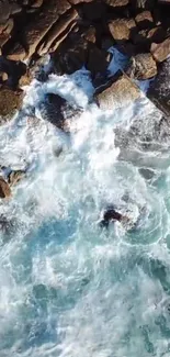 Aerial view of waves crashing on rocky coast with vibrant blue water.