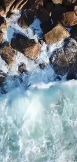 Aerial view of ocean waves crashing on rugged rocks.