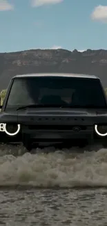 SUV crossing water in rugged terrain