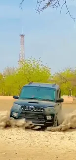 SUV powers through dusty terrain with green trees and clear sky backdrop.