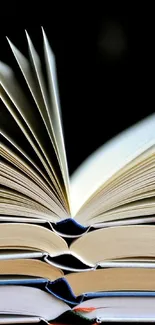 Open books with pages fanned, creating an elegant aesthetic on a black background.