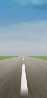 Open road leading to horizon under blue sky.