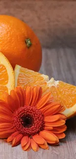 Vibrant wallpaper with oranges and an orange flower on wooden texture.