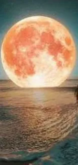 A vibrant orange moon over a serene beach during sunset.