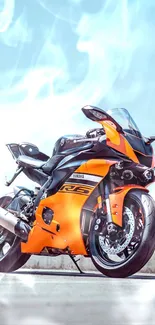 A sleek orange motorcycle posed on a scenic open road under a clear blue sky.