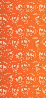 Vibrant orange wallpaper featuring a repeating skull pattern.