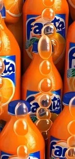 Vibrant Fanta orange soda bottles in a splashy design.