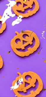 Purple Halloween wallpaper with pumpkin cookies.