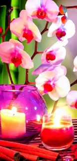 Vibrant orchids with candles and bamboo on a serene background.